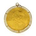 A 14 Karat Yellow Gold and Austrian Gold Coin Pendant