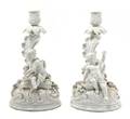 A Pair of Continental Blanc de Chine Figural Candlesticks