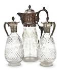 A Collection of Three Silverplate and Glass Claret Jugs