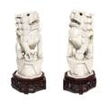 A Pair of Carved Ivory Fu Dogs