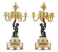 A Pair of Louis XVI Style Patinated and Gilt Bronze FiveLight Figural Candelabra