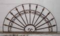 A Wrought Iron Arched Transom Grill
