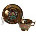 An English Copper Lustre Cup and Saucer