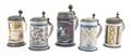 A Collection of Five Pewter Mounted Faience Steins