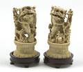 A Pair of Chinese Carved Ivory Fu Dogs