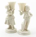 A Pair of Belleek Figural Candlesticks