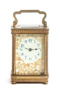 A French Gilt Bronze and Glass Carriage Clock