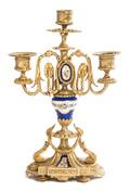 A Louis XVI Style Gilt Bronze and Sevres Style Porcelain Mounted TwoLight Candelabrum