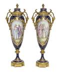 A Pair of Sevres Style Porcelain and Gilt Bronze Mounted Covered Urns