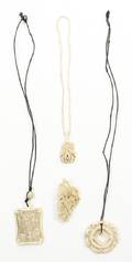 A Group of Four Ivory and Marine Ivory Pendants