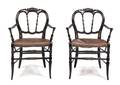 A Pair of Victorian Ebonized and Parcel Gilt Armchairs