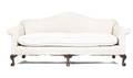 A Chippendale Style Carved Mahogany and Upholstered Camelback Sofa