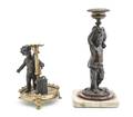 Two Metal Figural Putti Candlesticks