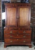 A Regency Mahogany and Ivory Inlaid Cabinet on Chest