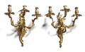 A Pair of Louis XV Style Gilt Bronze ThreeLight Wall Sconces
