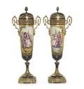 A Pair of Sevres Style Gilt Bronze Mounted Porcelain Urns and Covers