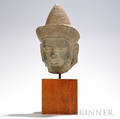 Carved Stone Head of a Deity Khmer Angkor periodstyle wearing a flared headdress with a coneshaped brim decorated with geometric