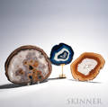 Three Geode Crosssection Discs each with hues of brown purple and blue sold with one stand ht to 12 14 wd to 15 14 in