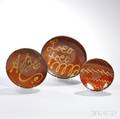 Three Slipdecorated Redware Plates