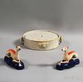 French White Faience Twopiece Plate Warmer and a Pair of Staffordshire Greyhound Whippet Figures