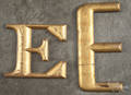 Two gilt store letters  E