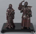 Pair of Japanese patinated bronze figures of a man and a woman with a rake and a broom