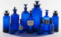 Twelve cobalt glass apothecary bottles