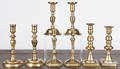 Four pairs of brass candlesticks