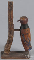 Carved and painted figure of a woodpecker