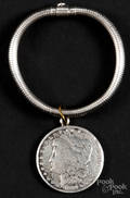 Sterling silver bracelet with an 1884 Morgan dollar charm