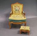 Louis XVstyle Carved Fruitwood Fauteuil and a Cast Iron Footstool
