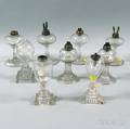 Nine Colorless Blown and Pressed Glass Fluid Lamps