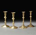 Two Pairs of Brass Petalbase Candlesticks