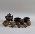 Eleven Brown to Blackglazed Jars