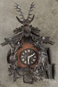 Black Forest carved cuckoo clock with a stag crest