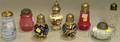 Eight Late Victorian Art Glass and Ceramic Sugar Casters