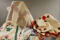 Three Handstitched Pieced Cotton Quilts and an Applique Quilt