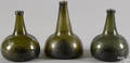 Three blown olive glass squat bottles late 18th c