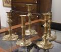 Five Early Brass Petalbase Candlesticks