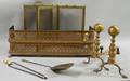 Small Pierced Brass Fireplace Fender a Pair of Brass Andirons a Small Brass Folding Fourpanel Fireplace Screen and a Pair of Firepl