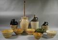 Three Stoneware Jugs a Sixgallon Butter Churn and Six Glazed Yellowware Kitchen Mixing Bowls