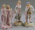 Pair of Continental Painted Bisque Renaissancestyle Figures and a Painted Bisque Figural Group