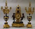 Threepiece Louis XVIstyle Cast Brass and Marblemounted Clock and Candelabra Garniture Set