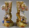 Pair of Continental Painted Bisque Boy and Girl Figural Group Spill Vases