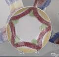 Two red green and yellow rainbow spatter drape saucers