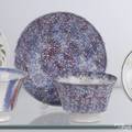 Red and blue mottled spatter cup and saucer
