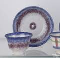 Purple and blue bullseye rainbow spatter cup and saucer