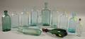Twelve Aqua and Colored Molded Glass Bottles