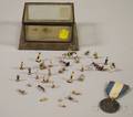 Pewter Rhode Island Ship Token and a Miniature Mexican Tin and Glass Display Box with a Collection of Painted Composition Figures