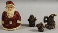 Four Painted Cast Iron Santa Claus Figural Doorstops and Paperweights